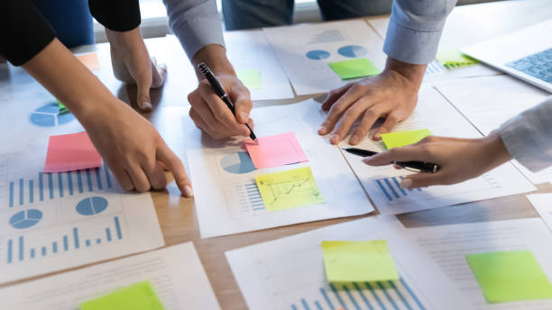 istock Close up diverse business people writing notes on stickers. 1278673208