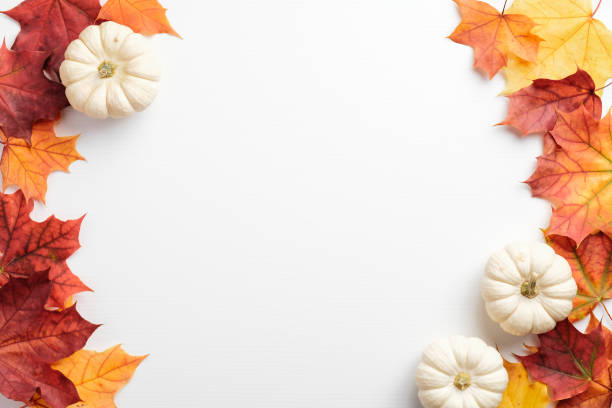 istock Autumn frame. Colorful maple leaves and pumpkins on white background. Flat lay, top view, copy space. Autumn fall, harvest, thanksgiving concept. 1278674059