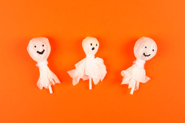 istock Halloween DIY concept. Make a cute ghost out of candy on a stick 1278674658