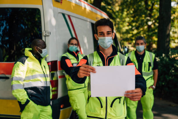 istock Paramedic is holding a blank sheet in front of the camera 1278675199