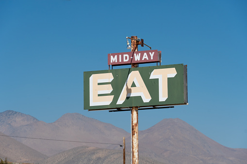 Old diner roadside sign MID-WAY EAT in the middle of the desert, Ridgecrest, California, USA, October 3rd