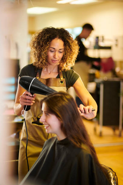 istock hair stylist with customer 1278681024