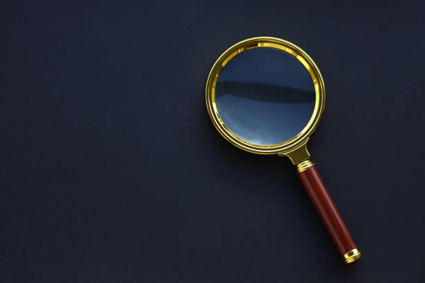 istock Magnifying glass on the black background. 1278683374