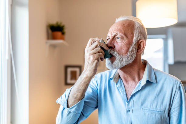 istock Mature man treating asthma with inhaler at home 1278685530