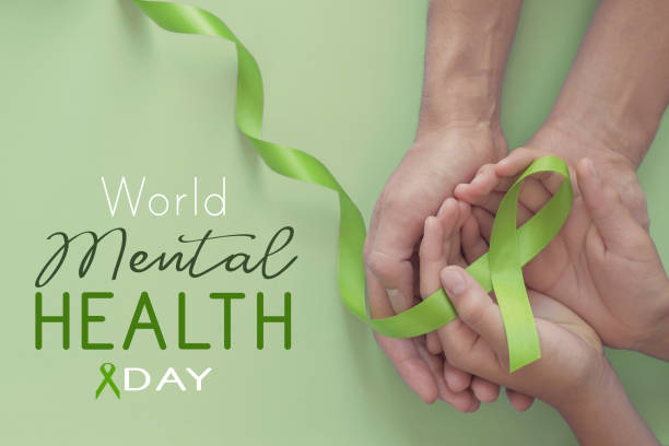 Adult and child hands holding Lime Green Ribbon on green background, world mental health day, Adult and child hands holding Lime Green Ribbon on green background, world mental health day, World Mental Health Day stock pictures, royalty-free photos & images