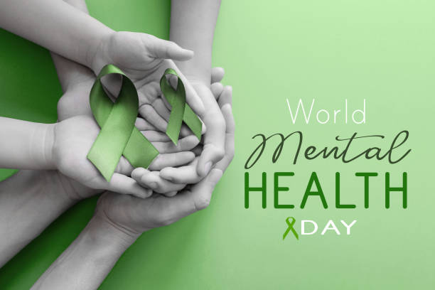 Adult and child hands holding Green Ribbon, World Mental Health Day stock photo