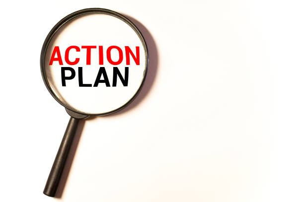 istock Hand holding magnifying glass with words action plan concept. 1278688286