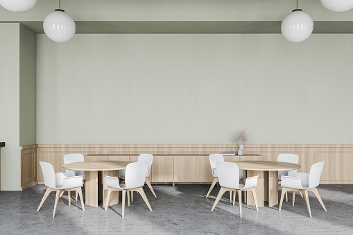 Interior of modern restaurant with white and wooden walls, concrete floor, round tables and white chairs. 3d rendering