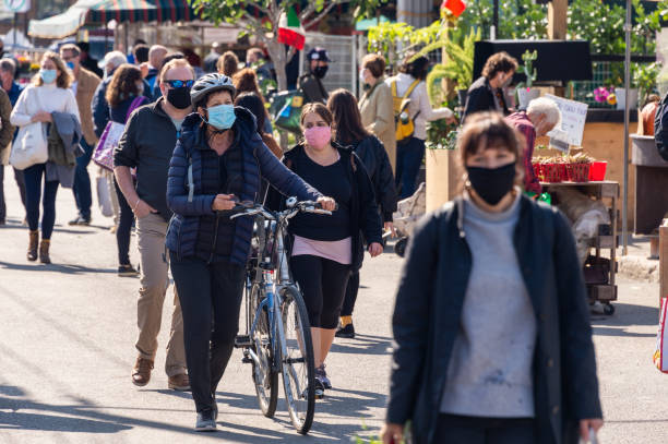 Many people wearing Coronavirus face masks at Jean Talon Market Montreal, CA - 4 October 2020: Many people wearing Coronavirus face masks at Jean Talon Market covid crowd stock pictures, royalty-free photos & images
