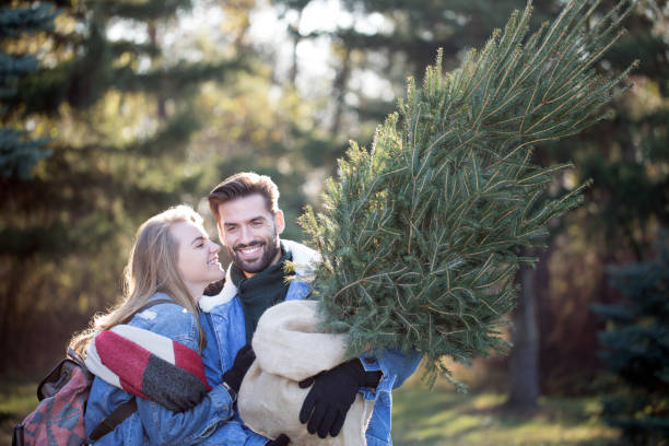 istock Couple in shopping for Christmass tree 1278693315