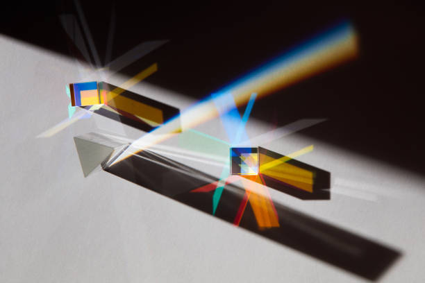 istock Glass geometric figures prisms with light diffraction of spectrum colors and complex reflection with trendy light and hard shadows on a white background 1278695357
