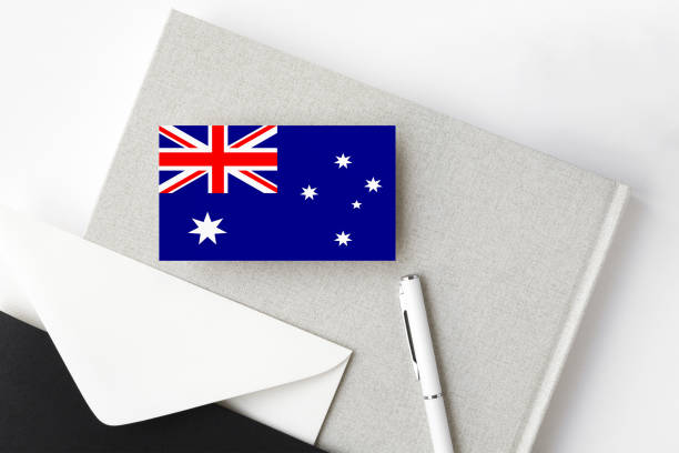 istock Australia flag on minimalist letter background. National invitation envelope with white pen and notebook. Communication concept. 1278695411