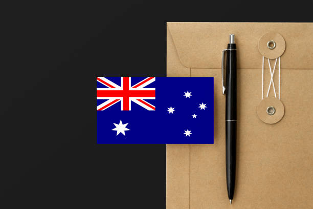 istock Australia flag on craft envelope letter and black pen background. National invitation concept. Invitation for education theme. 1278695421