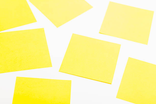 istock Sheets of yellow paper on a white background. Located randomly. 1278697985