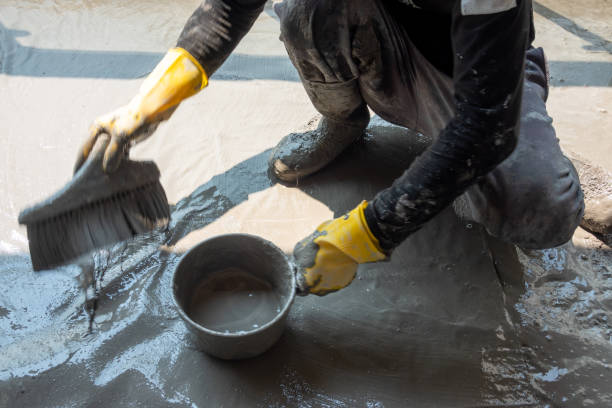 istock worker making textile with cement mixed with waterproof material on the floor 1278699609