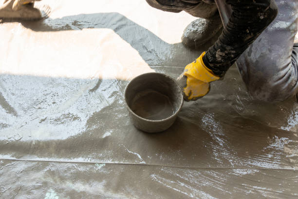 istock worker making textile with cement mixed with waterproof material on the floor 1278699617