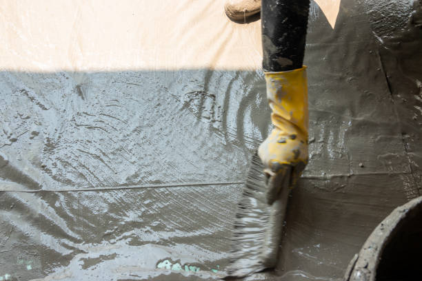 istock worker making textile with cement mixed with waterproof material on the floor 1278699645