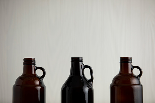 beer growler bottles for craft beer with white space for a copy over a white background