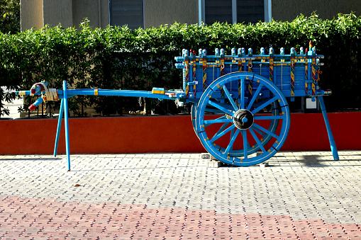 Blue colure  bullock cart with yellow, red and green strip park as attraction