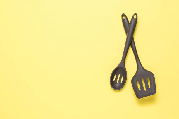 istock Two tablespoons of a silicone device on a yellow background. 1278709571