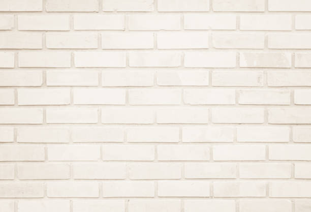 istock Empty Background of wide cream brick wall texture. Old brown brick wall concrete or stone pattern nature, wallpaper limestone abstract floor/Grid uneven interior rock. Home & office design backdrop. 1278709786