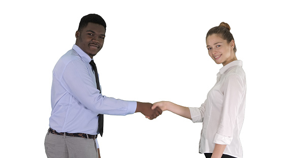 Medium shot. Handshake of business woman and business man posing for the picture on white background. Professional shot in 4K resolution. 012. You can use it e.g. in your commercial video, medical, business, presentation, broadcast