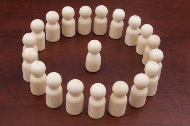 istock One female wooden figure surrounded by many figures. 1278714150