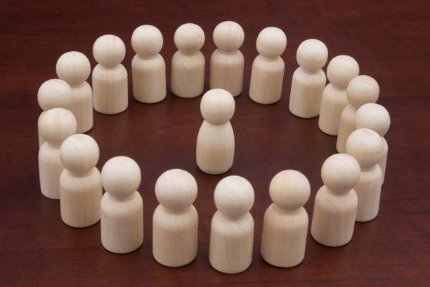 istock One female wooden figure surrounded by many figures. 1278714156