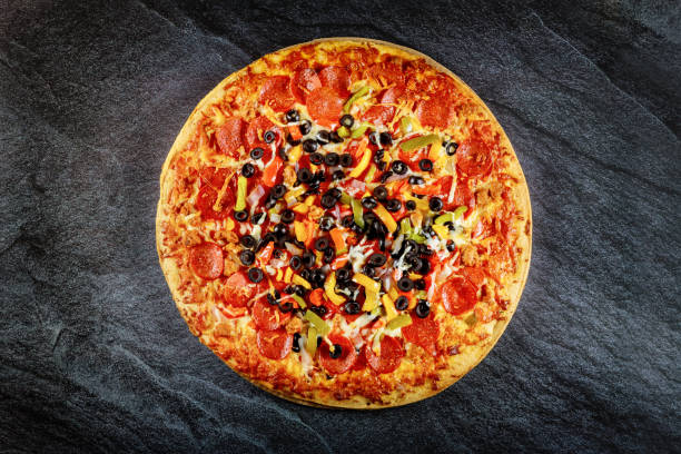 istock Supreme pizza with black olives and pepperoni. Close up. 1278720287