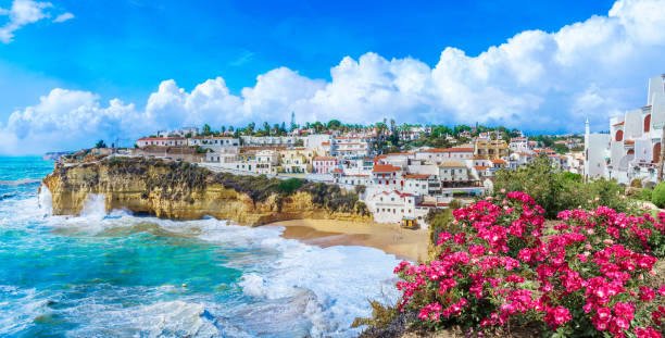 Carvoeiro town with colorful houses and yellow sand beach Carvoeiro town with colorful houses and yellow sand beach in Algarve, Portugal lagos portugal stock pictures, royalty-free photos & images