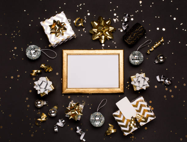 istock Christmas composition. Gold and silver decorations, mirror disco balls, gifts on  dark black background. 1278724287