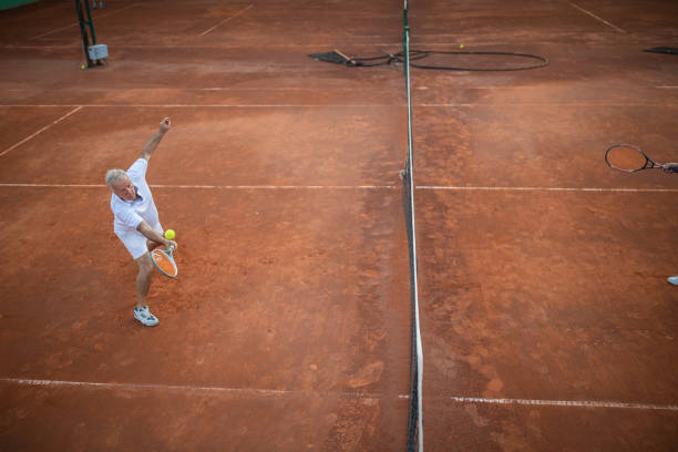 istock Senior man practicing volley technique on tennis court 1278726243