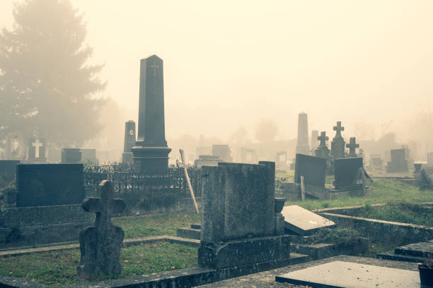 istock Old cemetery grave covered in autumn mist or fog 1278726321