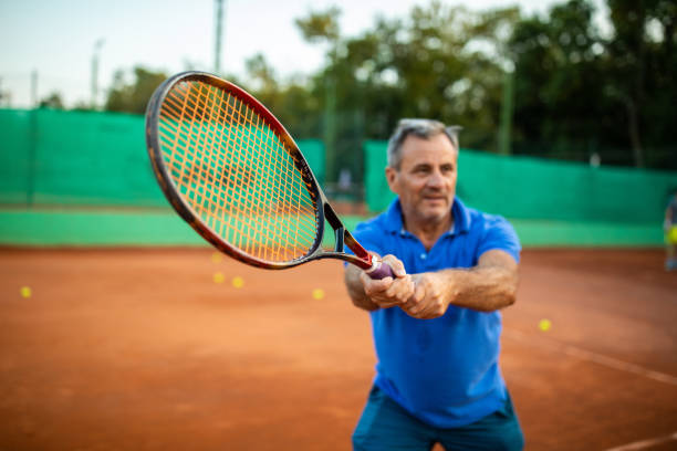 istock Senior tennis player playing tennis 1278726400
