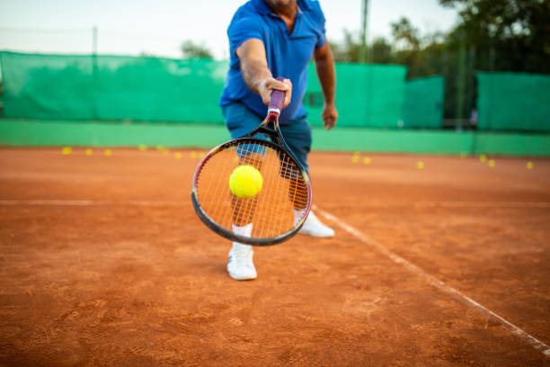istock Senior man practicing volley technique on tennis court 1278726422