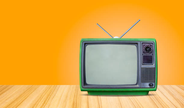 istock green retro old television receiver on table front gradient orange  wall background,perspective wooden floor texture and,vintage tv 1278727832