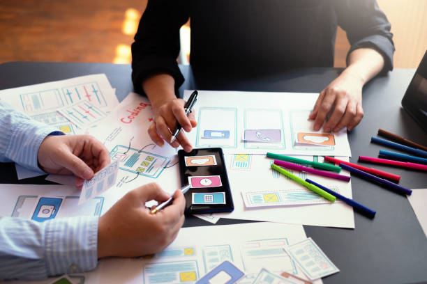 istock Creative planning and working mobile application design team in the office. 1278728648