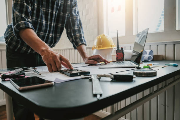 istock Architects or engineers draw a sketch on the blueprint and planning the construction project on table. 1278728852