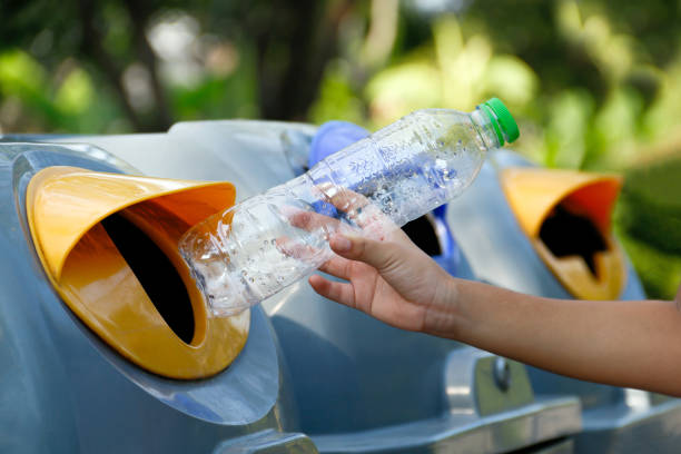 istock bottle plastic garbage waste in child's hand for throw in the trash bin, bin and hand holding bottle plastic, recycle garbage and segregation concept, bin of separation waste type 1278728971