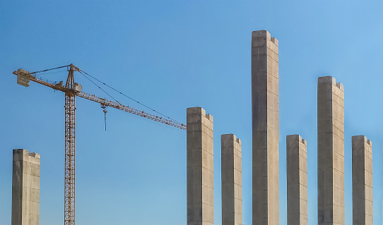 Construction crane working on concrete blocks