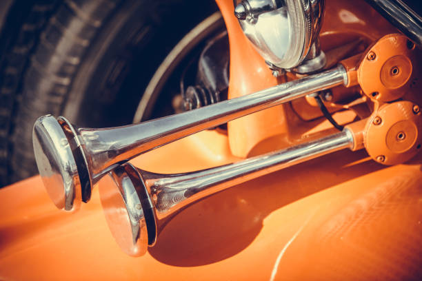 Close up shot of a vintage car double horn.