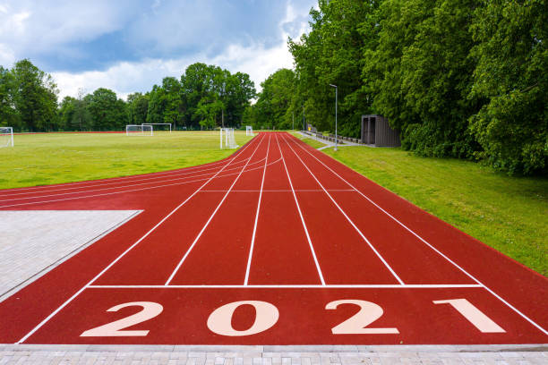 perspective view of an open - air stadium with red numbered running tracks