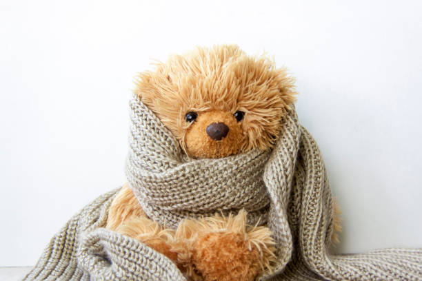 Toy bear in a warm scarf. Season of colds and infections. Strengthening of immunity.