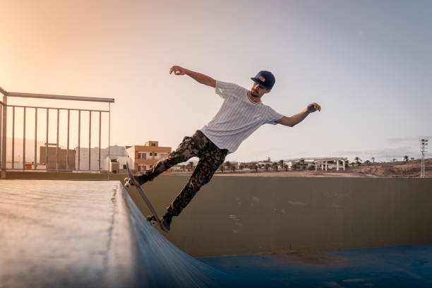 istock young skateboarder doing a backside 5-0 on ramp. Behind him, the sun is falling 1278738658