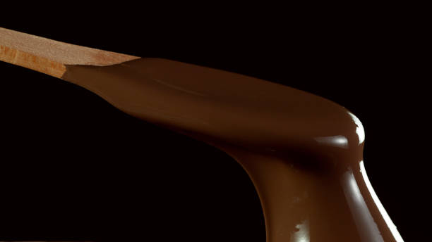 istock Wooden spoon stirring soft melted rich chocolate 1278739345
