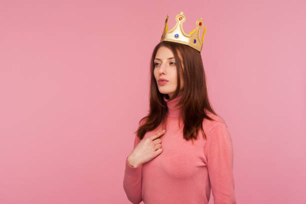 istock Ambitious self-confident authoritative woman wearing crown on head and pointing finger at herself, looking with arrogance 1278743942