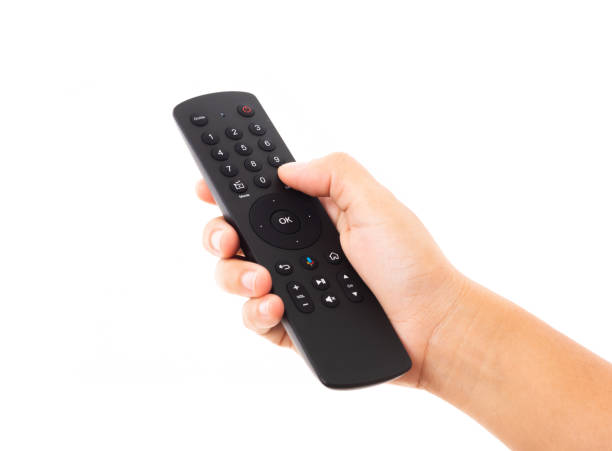 istock Hand holding television and audio remote control 1278745382