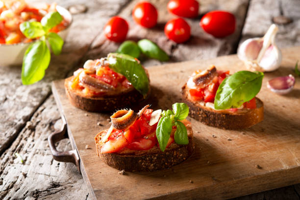 istock Bruschetta with tomato, basil anchovy and olive oil 1278745758