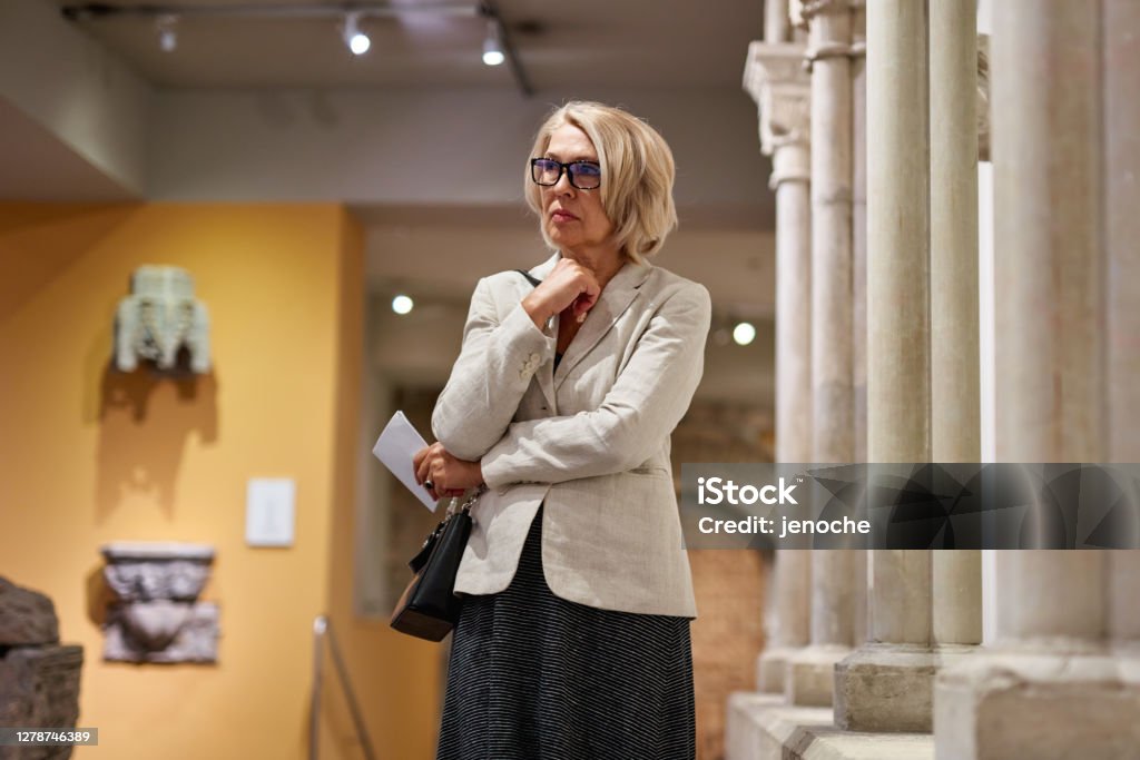 Portrait of a woman visiting historical museum Critic Stock Photo