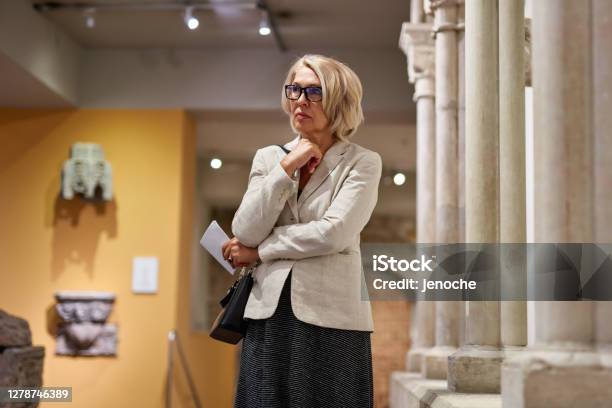 Portrait Of A Woman Visiting Historical Museum Stock Photo - Download Image Now - Critic, Art, Museum